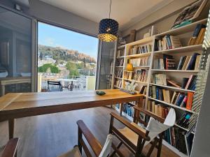 a dining room with a table and bookshelves at Luxurious Top Floor Acropolis View Loft in Plaka - Newly Refurbished in Athens