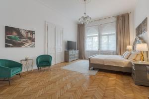 a bedroom with a bed and a desk and chairs at UNIQUE EXPERIENCE at Rimanóczy Palace Oradea in Oradea +8 photos