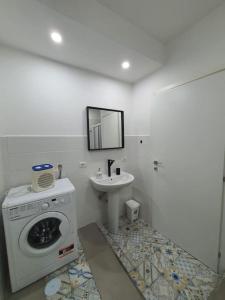 a bathroom with a washing machine and a sink at Urban Chic Guest House free Wi-Fi- in Salerno +8 photos