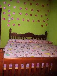 a bedroom with a bed with flowers on the wall at Bulnewa Grammar International home stay/Tree-house 