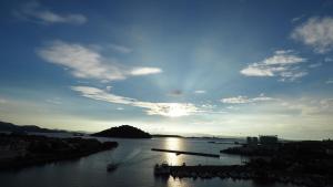 a view of a body of water with the sun setting at 大村ヤスダオーシャンホテル in Omura