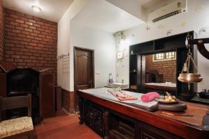 a large kitchen with a counter top in a room at Balkatmane Heritage Spa Resort Udupi in Udupi