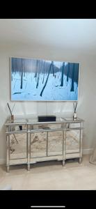 a large television on a wall in a living room at Luxury HomeStays - Hot Tub - Sea Views - Sleeps 8 in Portsmouth