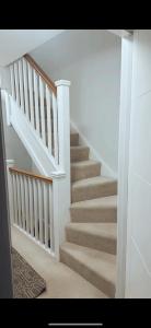 a staircase in a home with white walls at Luxury HomeStays - Hot Tub - Sea Views - Sleeps 8 in Portsmouth
