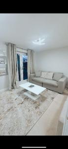 a living room with a couch and a table at Luxury HomeStays - Hot Tub - Sea Views - Sleeps 8 in Portsmouth