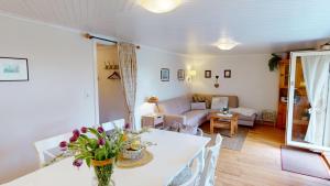 a living room with a table and a couch at Gollendorf "Vier Pfoten" in Fehmarn