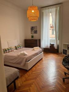 a bedroom with two beds and a large window at Aldebaran in Milan