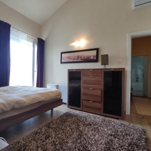 a bedroom with a bed and a dresser and a window at Suntime villa Laguna in Bigova +17 photos