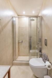 a bathroom with a shower with a toilet and a sink at Camara Residence in Chania