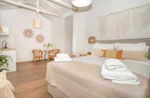 a bedroom with a large bed with towels on it at Camara Residence in Chania