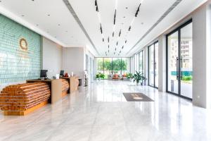 an office lobby with a reception desk and large windows at The Q Residence Vientiane in Vientiane