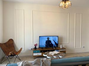 a living room with a tv and a couch at Old Town Overlooking - Vibrant 2BR Apartment in Bucharest