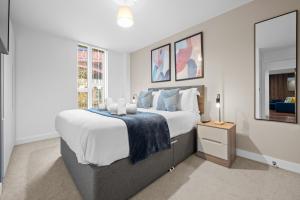 One Cambridge Residence by COQOON في مانشستر: غرفة نوم بسرير كبير ونافذة