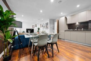 a kitchen and dining room with a table and chairs at Sleek & Contemporary - Central Urban Hideout in Manchester