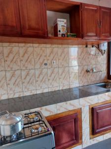 a kitchen with a stove with a pot on it at Résidence beau-lieu in Yaoundé