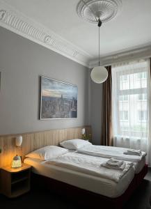 a bedroom with a large bed and a large window at Hotel Kieler Hof am Hauptbahnhof - Hamburg Central Station in Hamburg