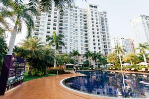 a large apartment building with a large swimming pool at The Q Residence Vientiane in Vientiane