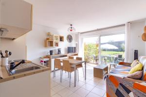 cocina y sala de estar con fregadero y mesa en Le Jouarres - Appt climatisé avec piscine partagée, en Azille