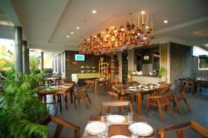 a restaurant with wooden tables and chairs and a chandelier at Boloti Camp resort in Lemira