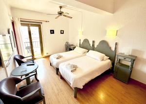 Postel nebo postele na pokoji v ubytování Hotel Marbel