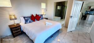 a bedroom with a large bed and a bathroom at Alomsee 10 - Sleeps 8 with amazing views of the sea in Margate
