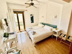 a bedroom with a bed and a table and a window at Hotel Marbel in Cala Ratjada