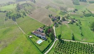 an aerial view of a house in a field at Casale Gioia in San Marzano Oliveto
