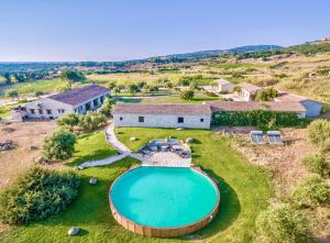 an aerial view of a house with a swimming pool at Residence with swmming-pool in Badesi, apartments with private outdoor area in Badesi