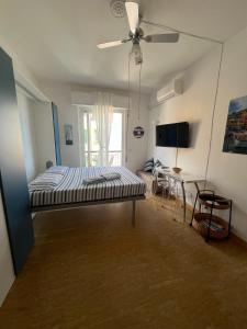 a bedroom with a bed and a ceiling fan at Tigullio 38 by PortofinoVacanze in Rapallo +14 photos
