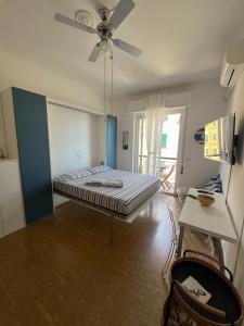 a bed in a room with a ceiling fan at Tigullio 38 by PortofinoVacanze in Rapallo
