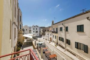 a view of an alley with benches and buildings at Casa Coralli Centro Storico by CASASI Vacanze Otranto in Otranto