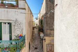 an alleyway between two buildings in an old town at Casa Coralli Centro Storico by CASASI Vacanze Otranto in Otranto