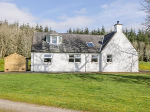 een wit huis met een gambrel dak bij Glen View in Dumfries