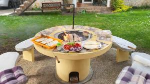 a picnic table with food on top of it at Liget Nyaralóház és Apartman Liget in Szilvásvárad