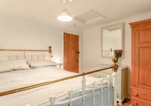a bedroom with a white bed and a window at The Annexe at Hideaway Cottage in Ellingham