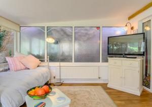 a room with a bed and a large window at The Annexe at Hideaway Cottage in Ellingham