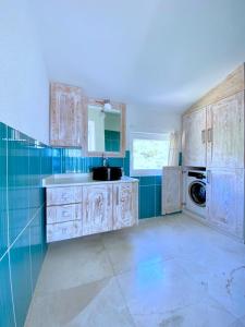 a kitchen with white cabinets and a sink at Akdeniz Villa in Kas