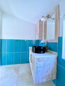a bathroom with a sink and blue walls at Akdeniz Villa in Kas