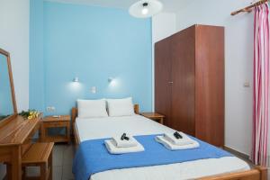 a bedroom with a bed with two towels on it at Kalami apartment with seaview in Falasarna
