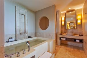 a bathroom with a tub and a sink at ShaSa Resort & Residences, Koh Samui - SHA Extra Plus in Lamai