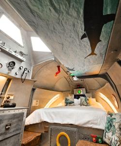 a room with a bed and a painting on the ceiling at The Yellow Submarine in Cheddar