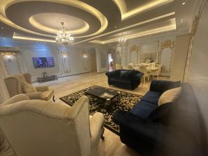 a large living room with couches and a table at Dreamland villa in ‘Ezbet `Abd el-Ḥamîd