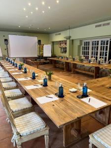 a long wooden table in a large room with benches at Hotel Valdepalacios Gourmand 5* GL in Torrico