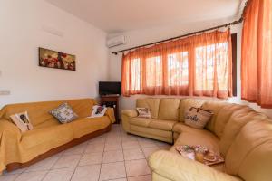 a living room with two couches and a couch at Villa Minoa con piscina in San Vito lo Capo