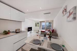 eine Küche und ein Wohnzimmer mit einem Tisch und Stühlen in der Unterkunft Red View Apartment - Happy Rentals in Ronco sopra Ascona