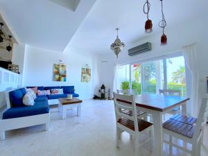 a living room with a table and a blue couch at AkdenizVillas in Kaş
