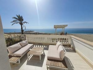 balcón con sofás y vistas a la playa en Blu Sea apartments, en Pietra Ligure