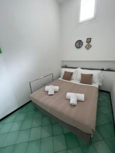 a bedroom with a large bed with towels on it at Casa Positano in Positano