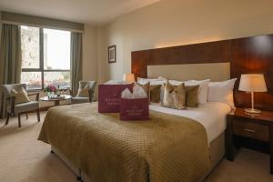 a hotel room with a bed with two boxes on it at Trim Castle Hotel in Trim