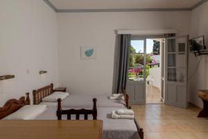 A bed or beds in a room at Irene Hotel Leros